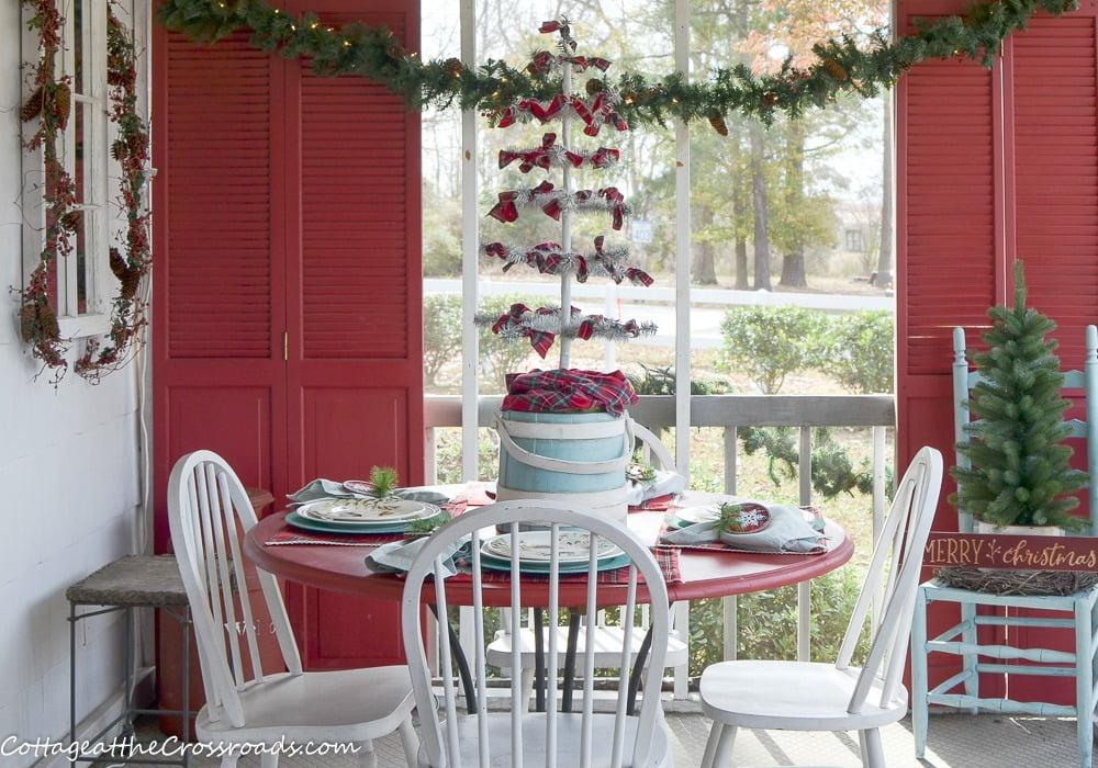 Table on a plaid and aqua christmas porch