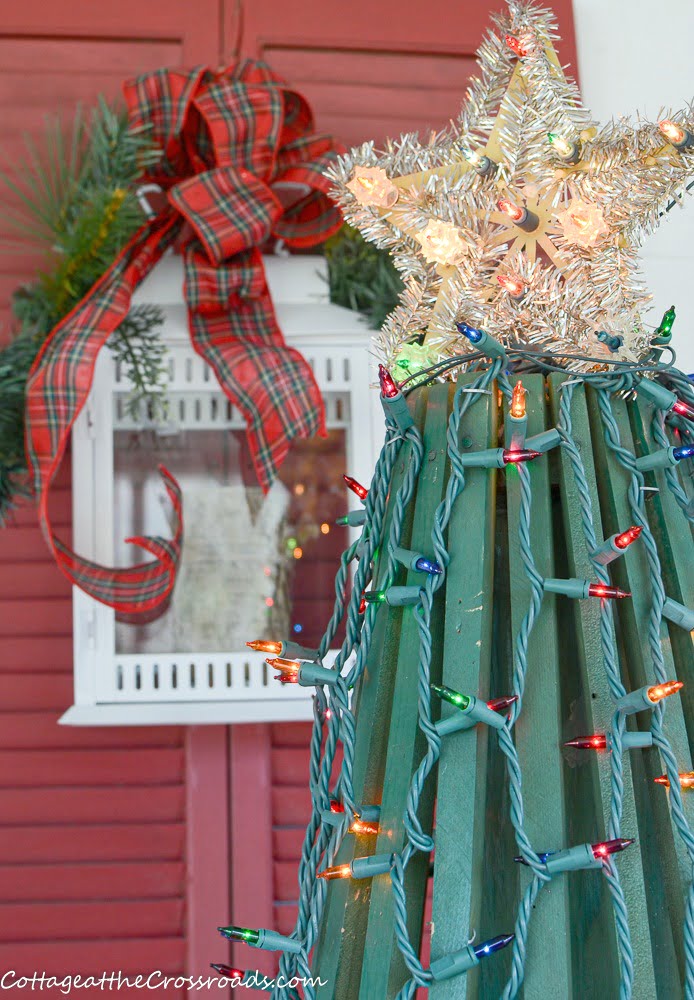 Vintage wooden christmas tree with a tinsel star