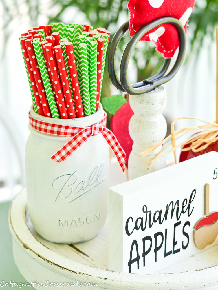 Painted ball jar with red and green straws