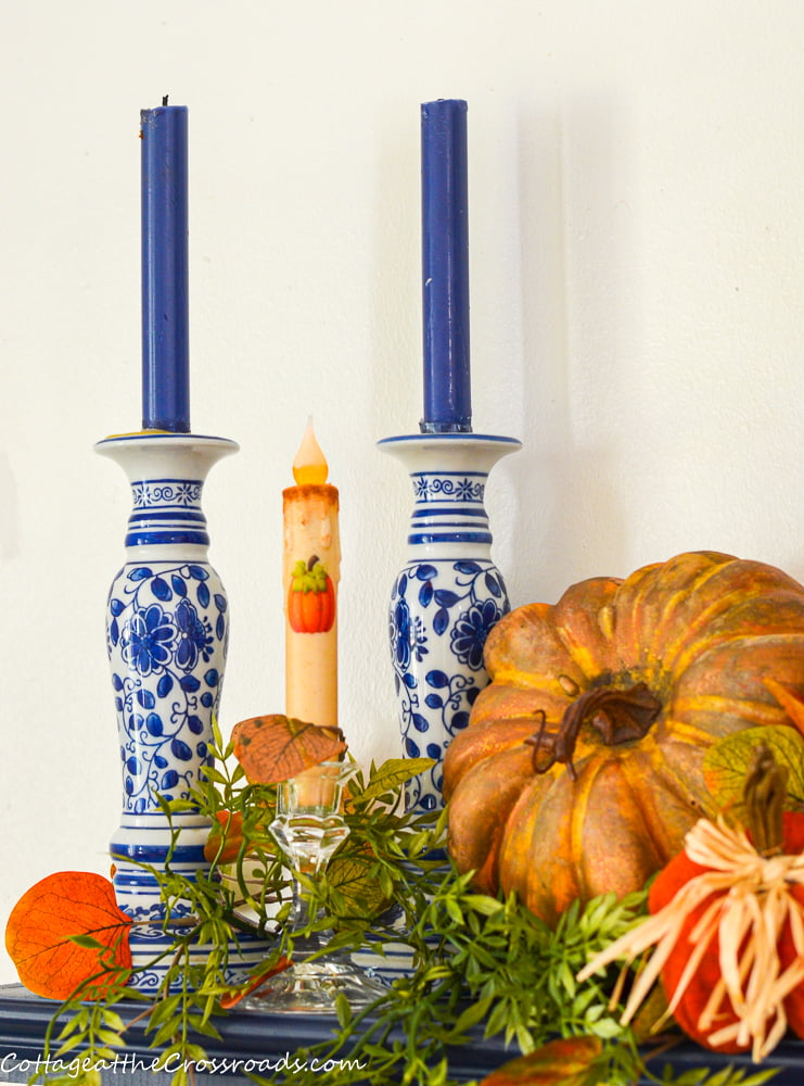 Blue and white candlesticks on a fall mantel