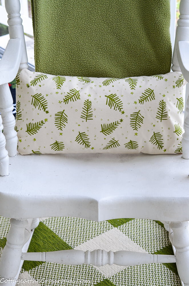 Green pillow and throw in rocking chair
