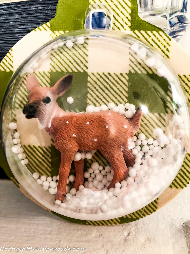 Snow globe ornament with deer