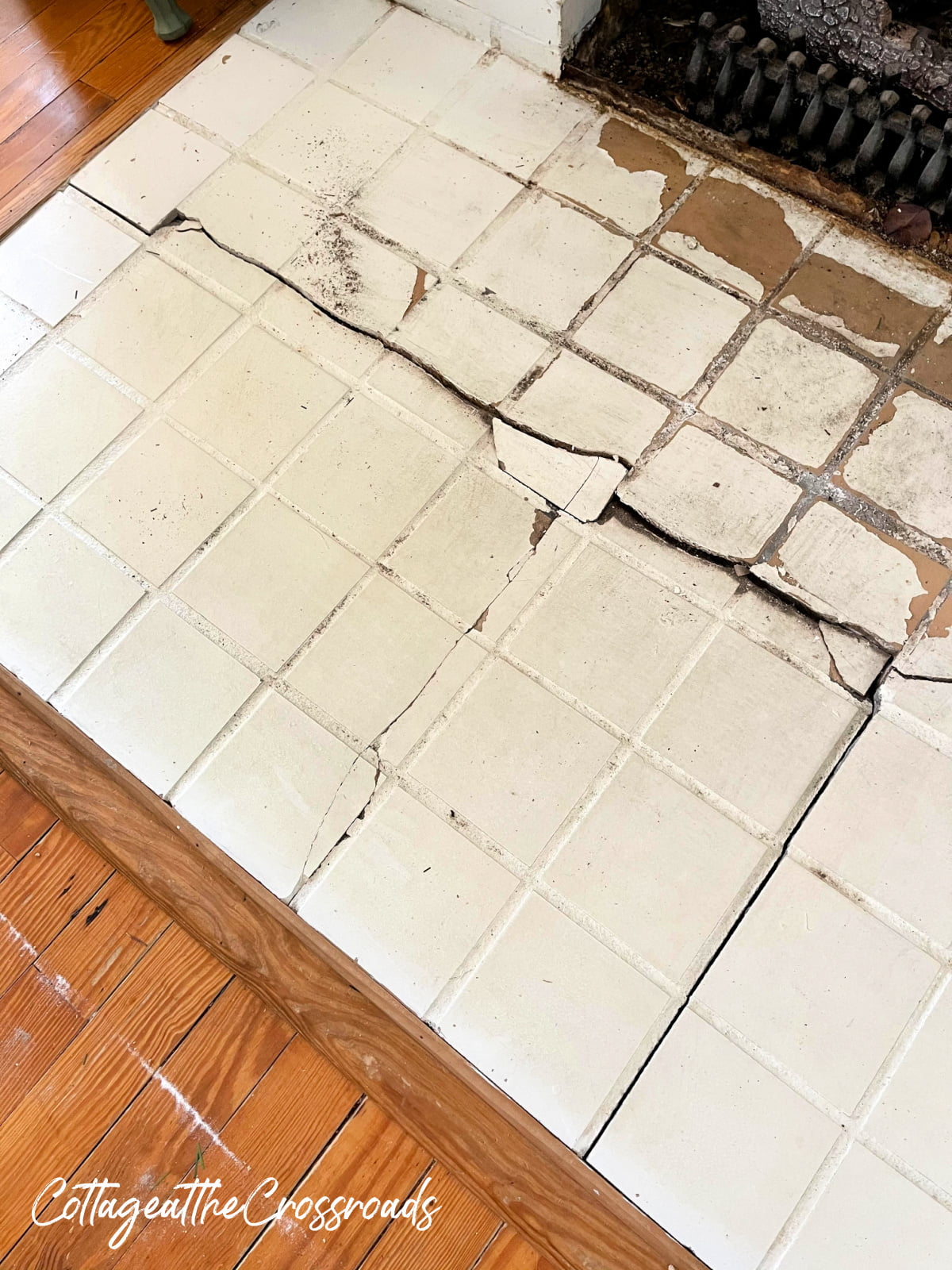 Cracked tile and sunken floor near fireplace