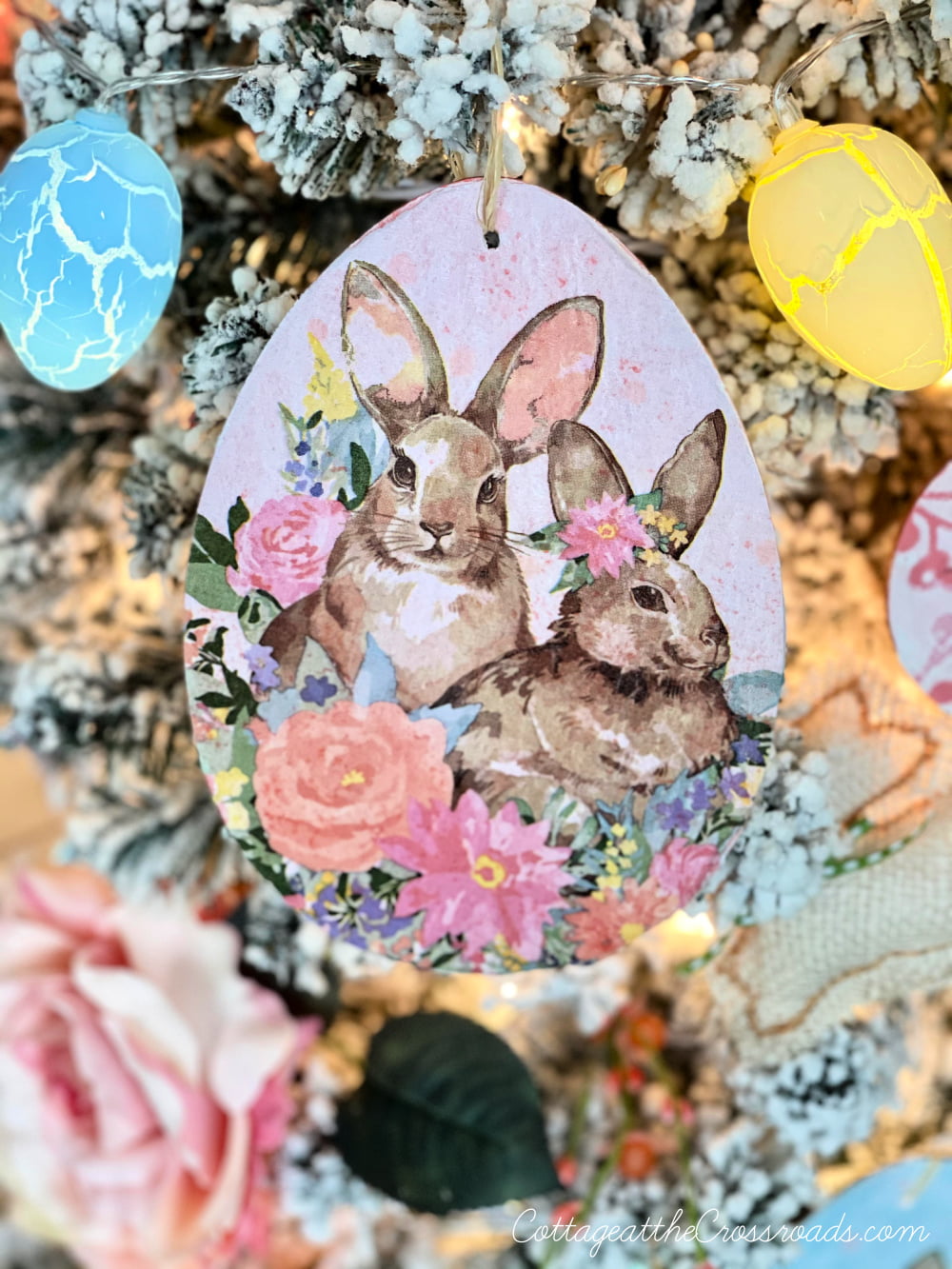 Decoupaged bunnies on a wooden easter egg