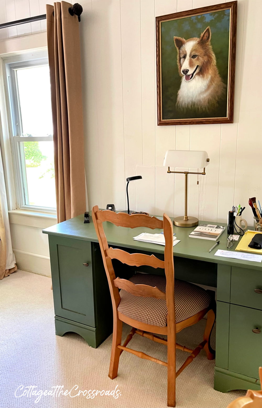 Green desk and dog portrait above