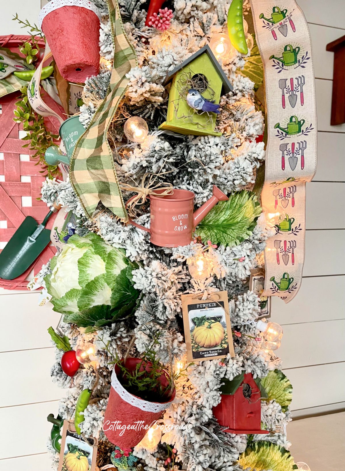 Watering can ornament on garden tree