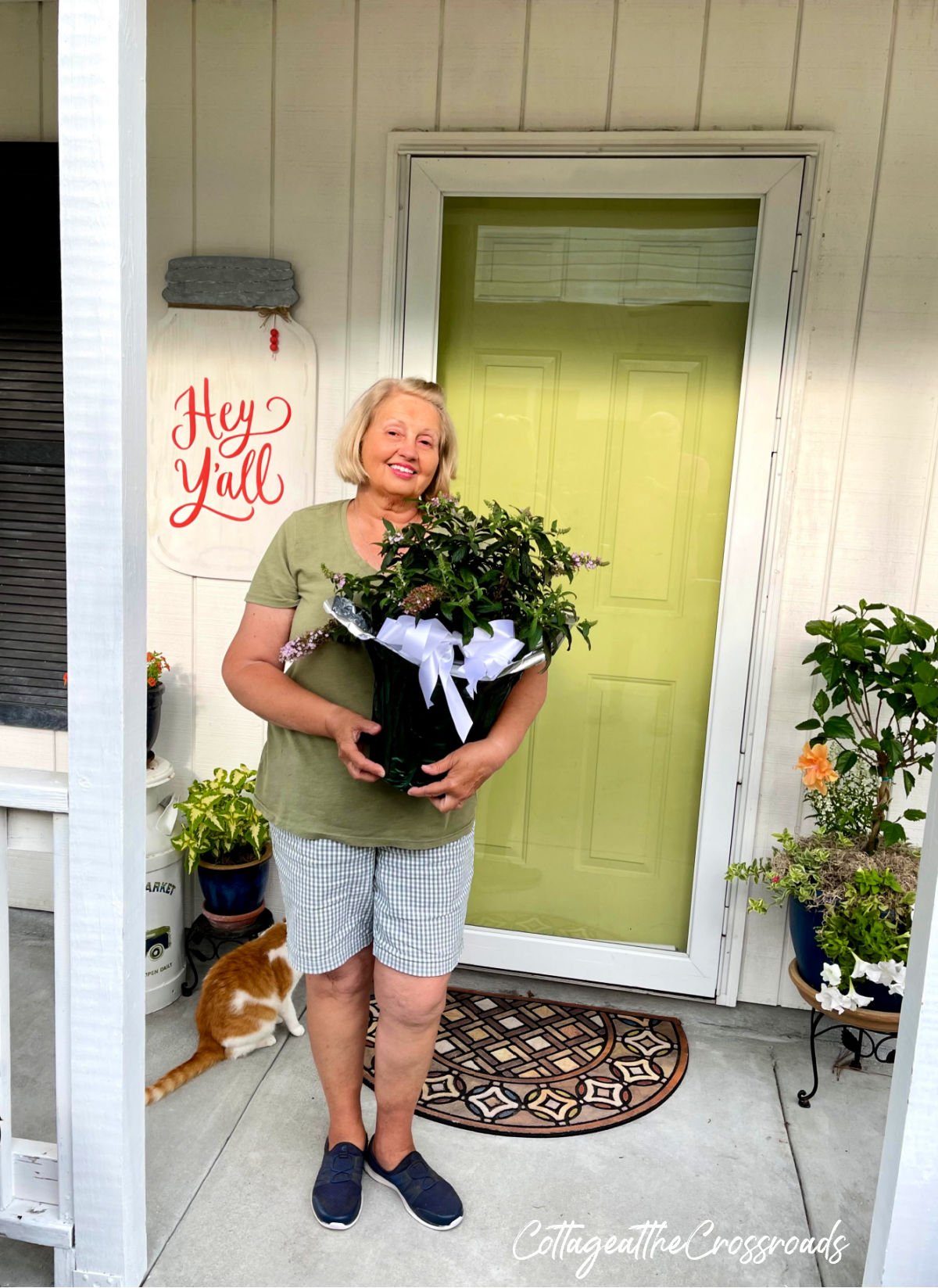 Jane from cottage at the crossroads holding a butterfly bush