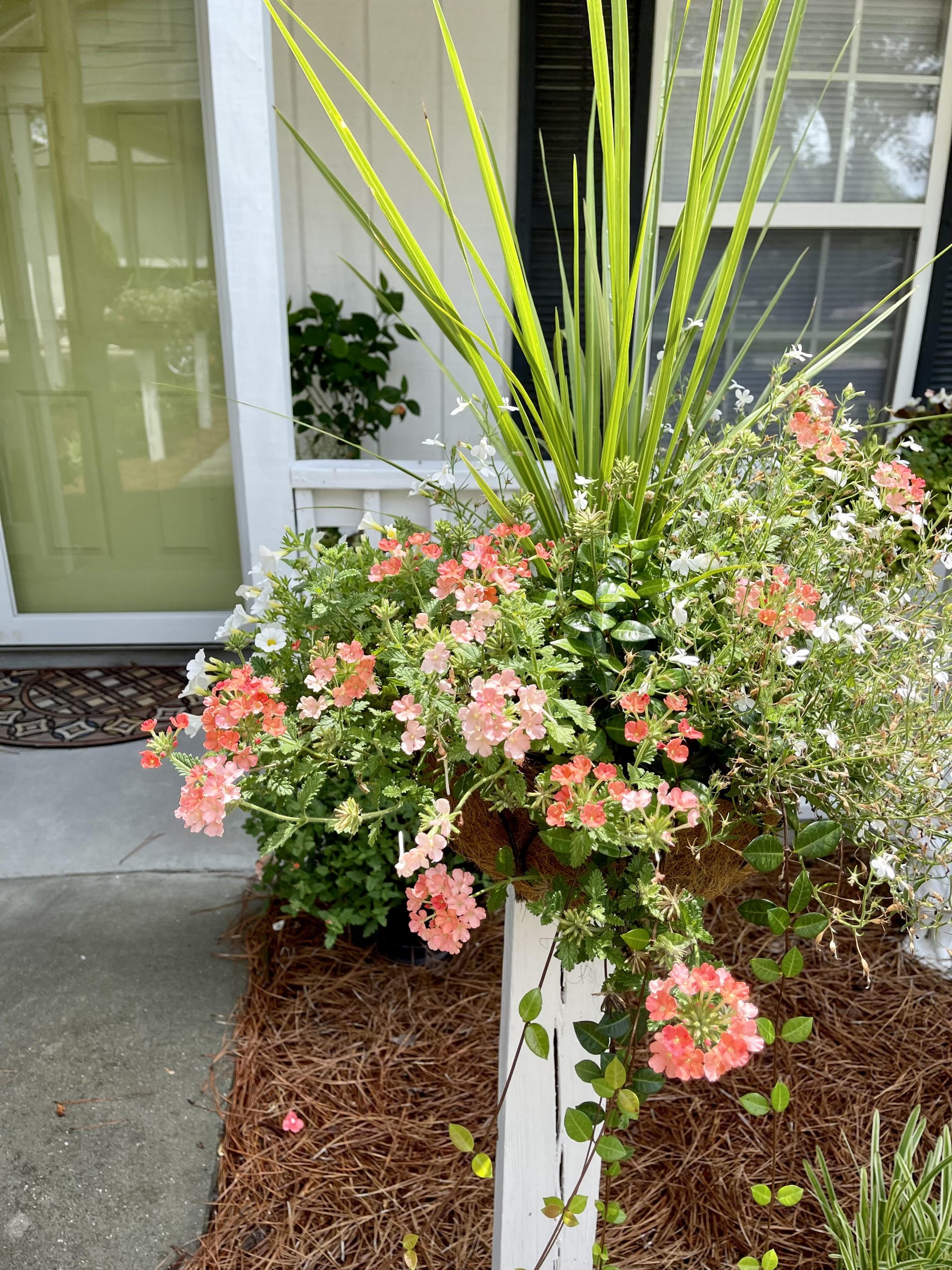 Flowers in baskets mounted on wooden posts