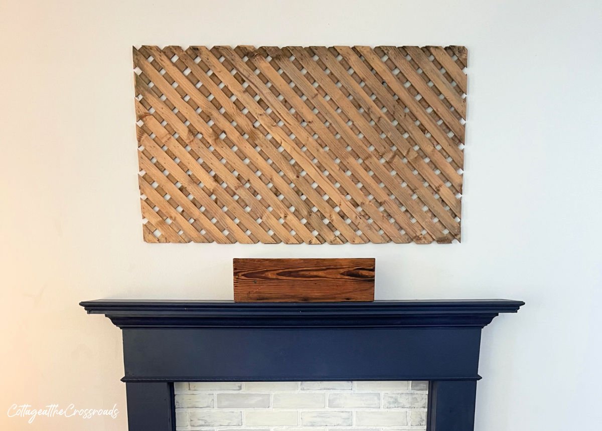 Wooden lattice panel mounted above a mantel