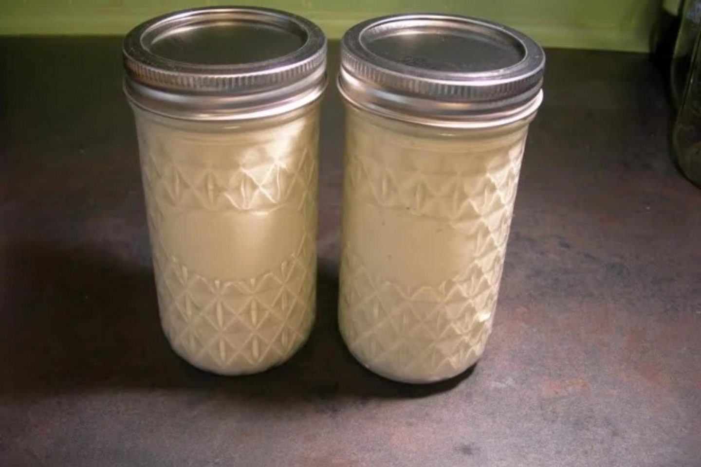Sealed jars with cucumber salad dressing