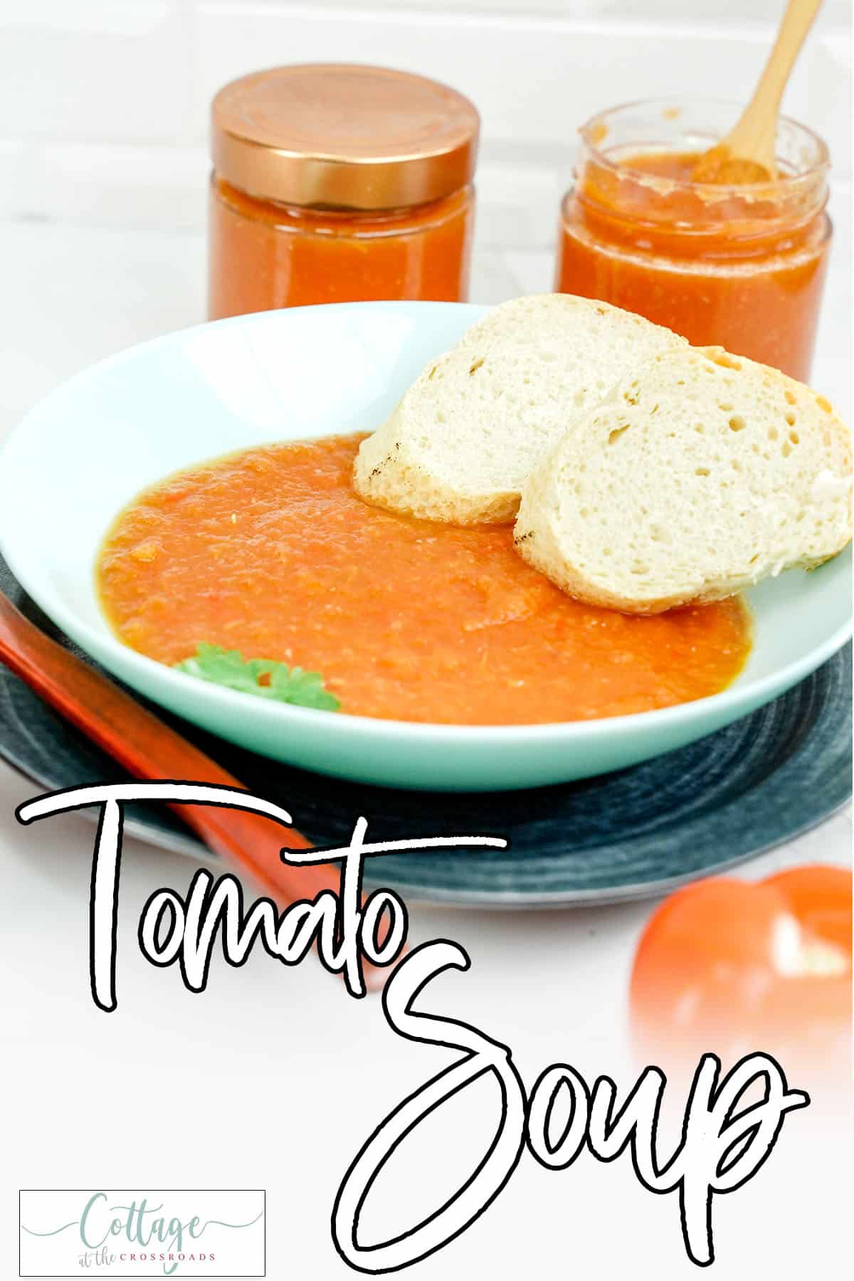 Bowl of homemade tomato soup with text which reads tomato soup