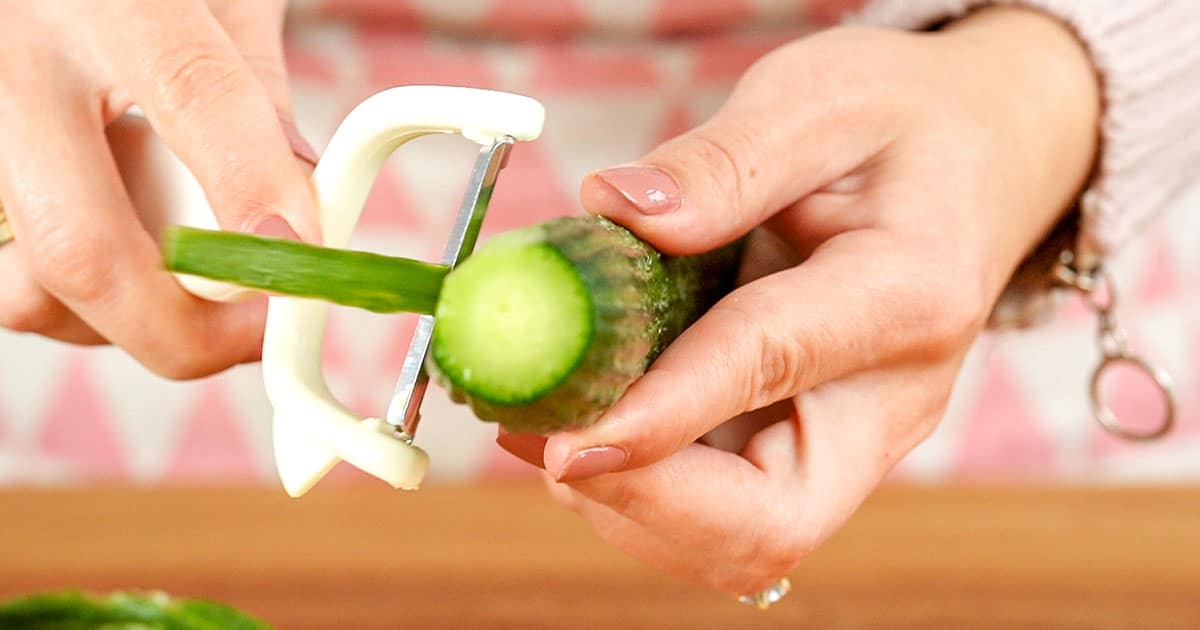 Cucumber being peeled to make cucumber ranch dressing