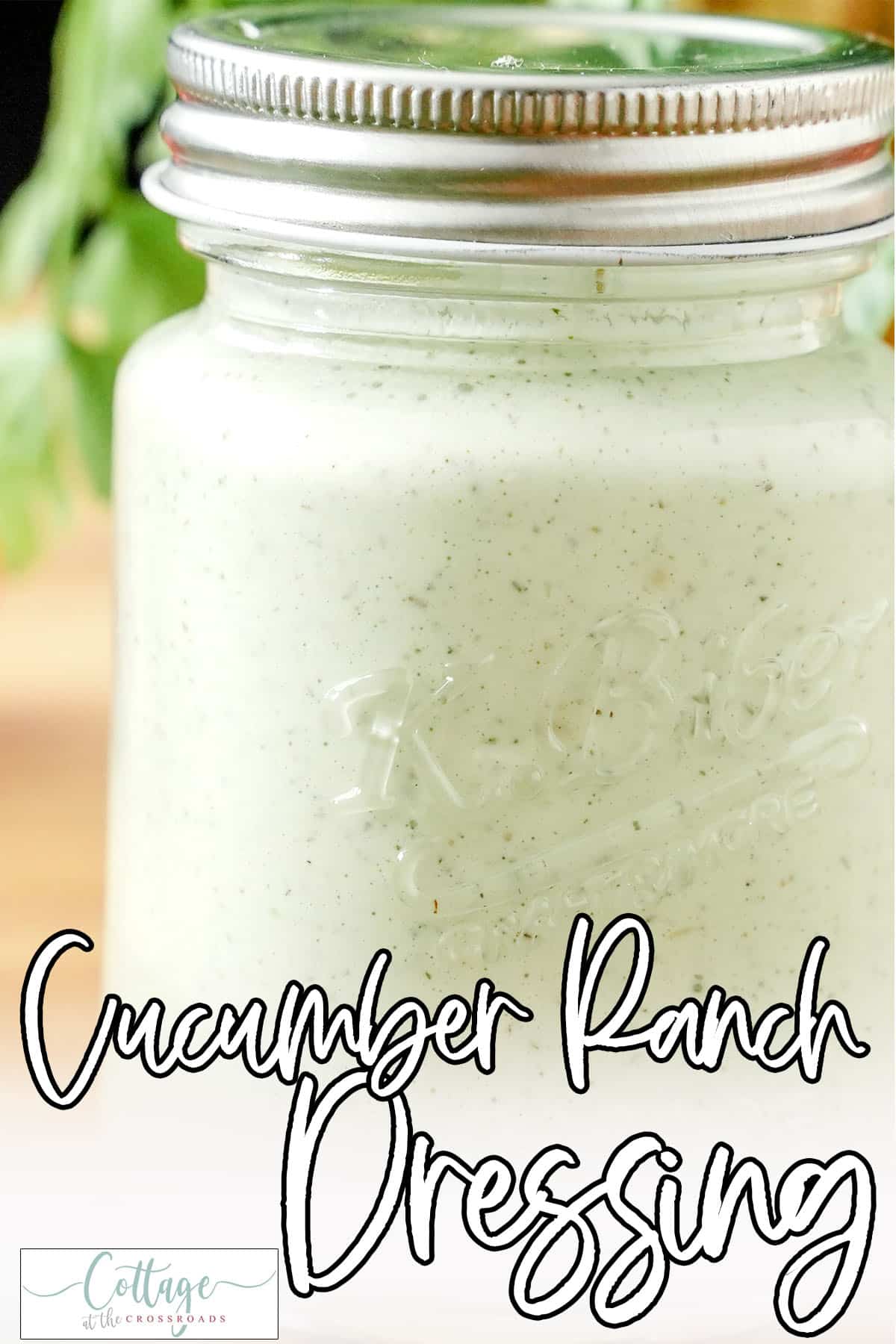 Closeup of jar of homemade ranch dressing with text which reads cucumber ranch dressing
