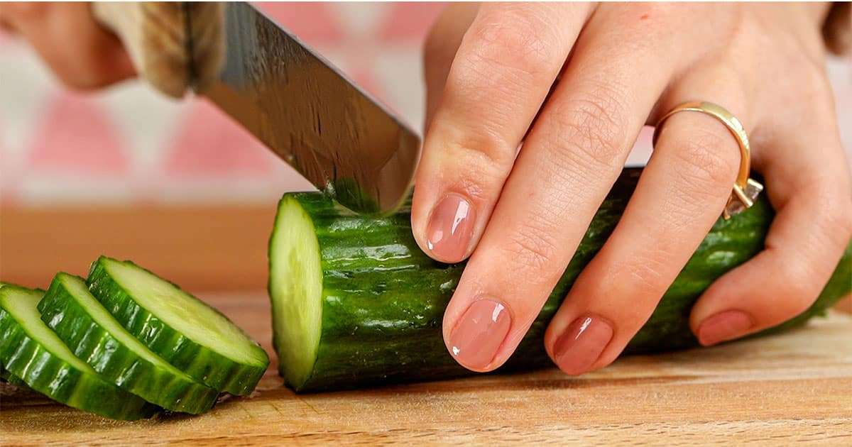 Cucumbers being sliced to make cucumber salad