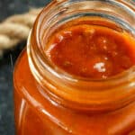 Closeup of opened jar of enchilada sauce