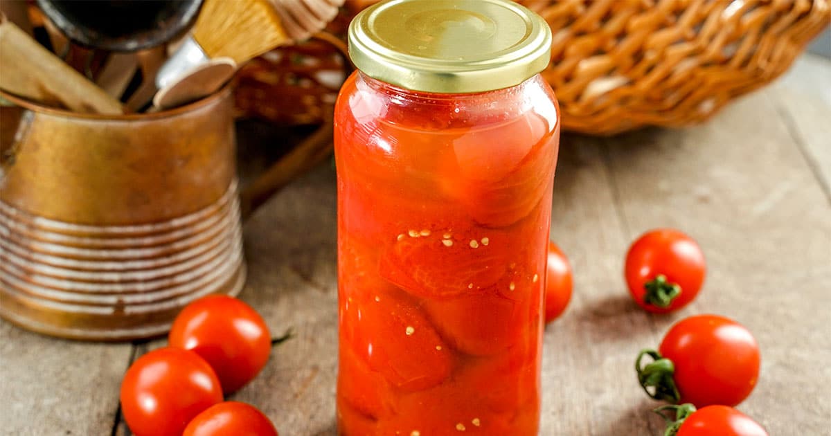 Closeup of a jar of homemade canned whole tomatoes