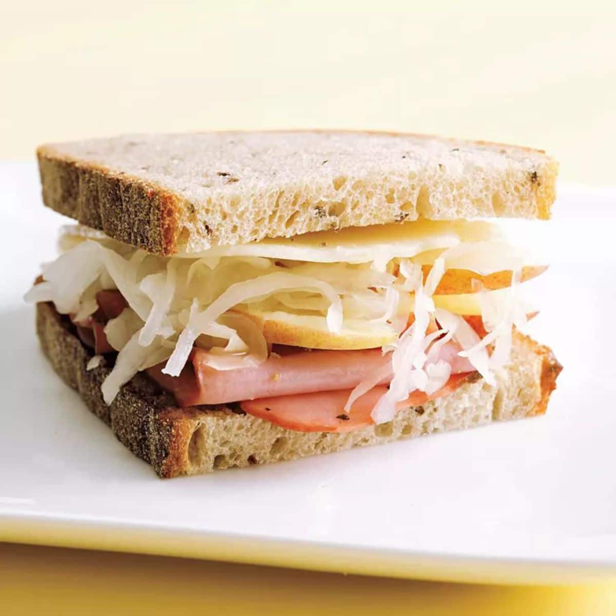 Turkey pastrami sandwich on a white tray.