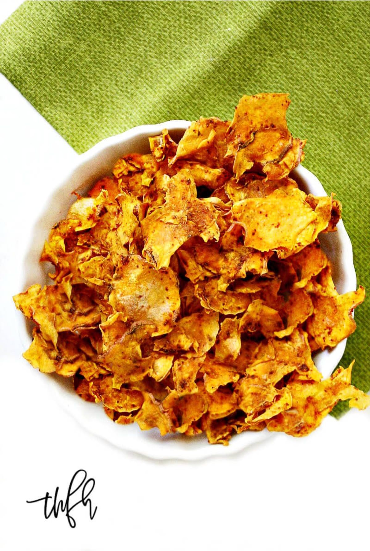 Dehydrated sweet potato chips in a white bowl.