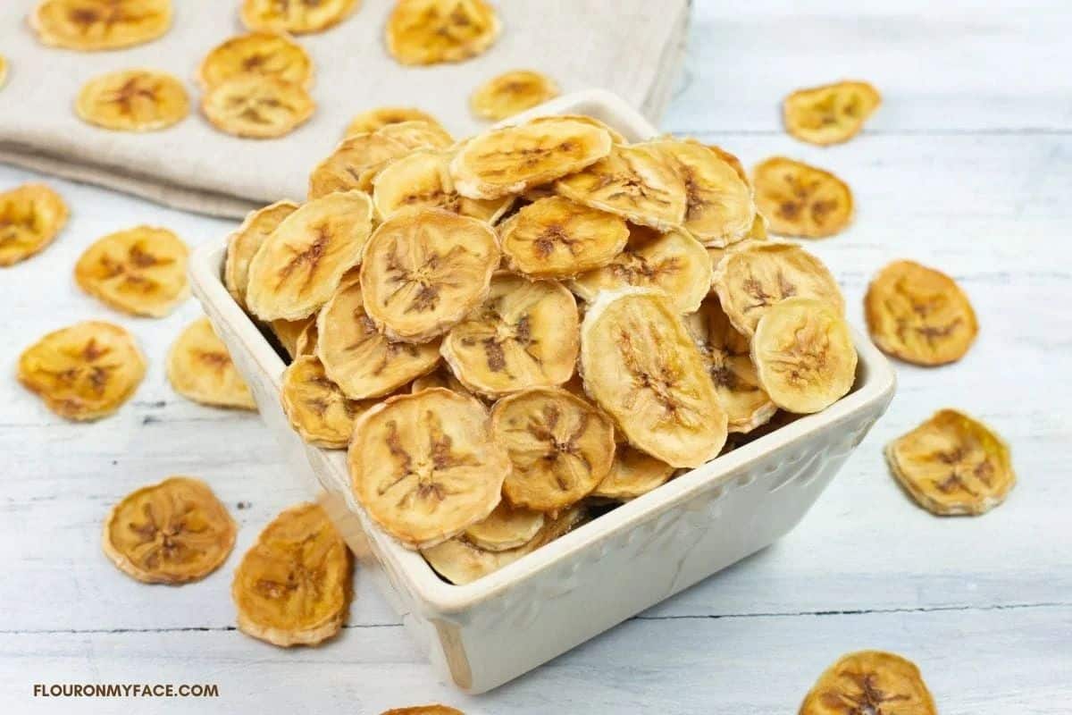 Banana chips in a white bowl.