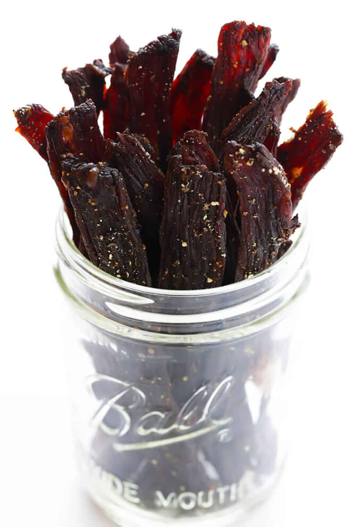 Beef jerky in a glass jar.