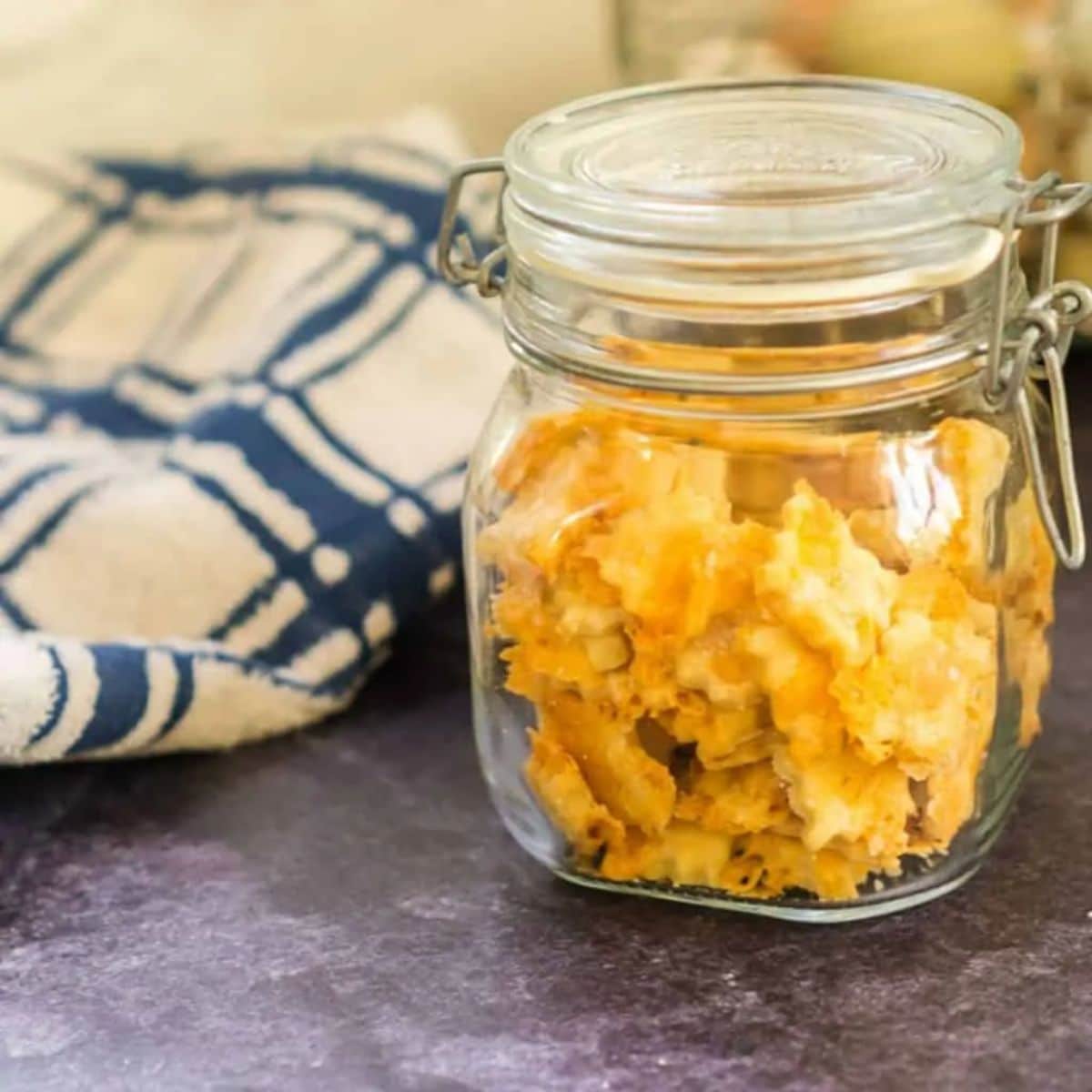 Sourdough cheddar crackers in a glass jar.