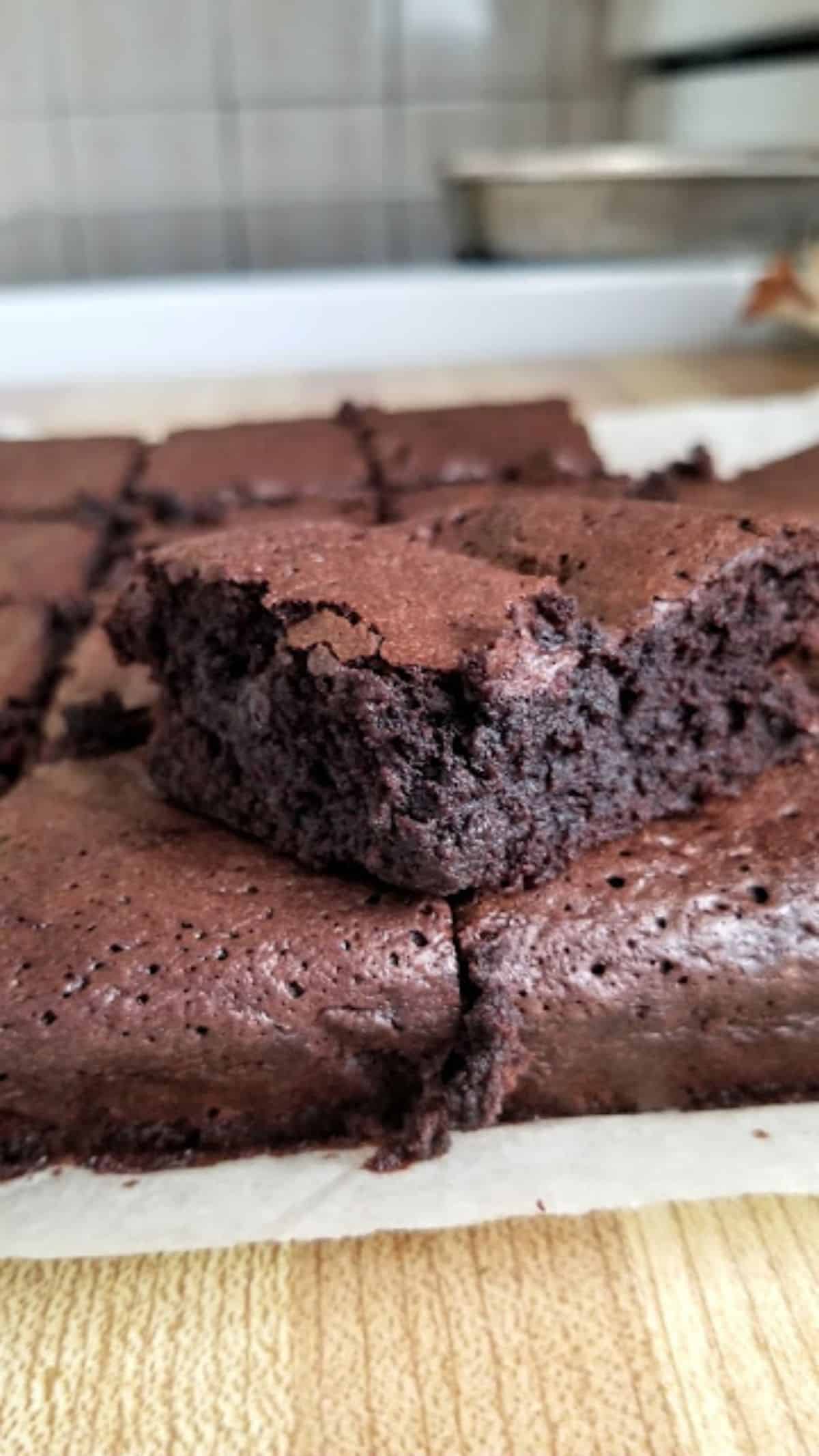 Sourdough discard brownies on parchment paper.