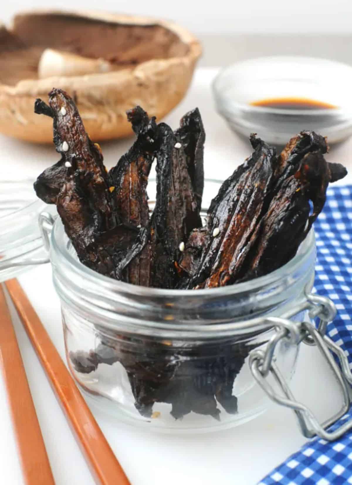 Teriyaki mushroom jerky in a glass jar.