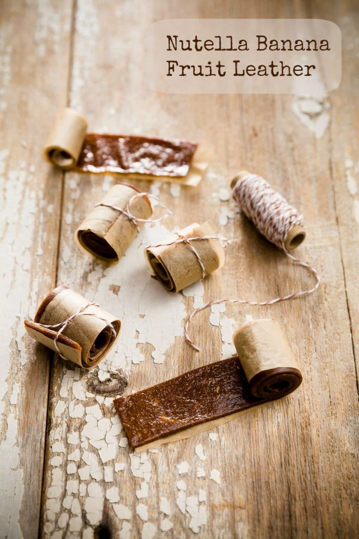 Banana fruit leathers with nutella on a wooden table.