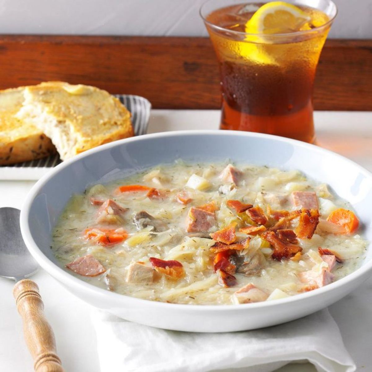 Slow-cooked sauerkraut soup on a white plate.