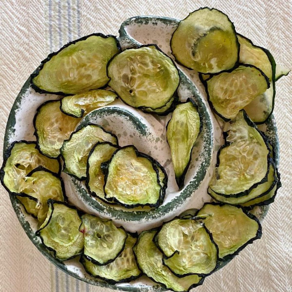 Salt and vinegar cucumber chips on a cool-looking tray.