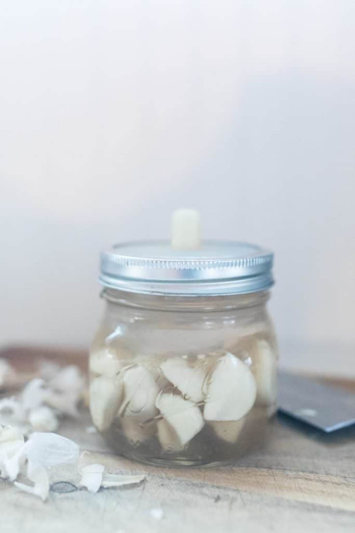 Lacto fermented garlic in a glass jar.