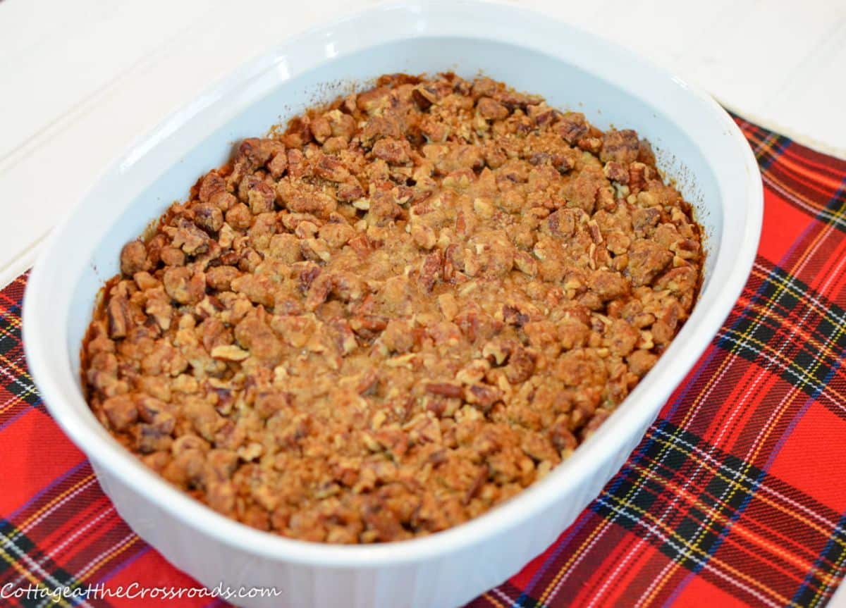 Grated sweet potato pudding in a white casserole.