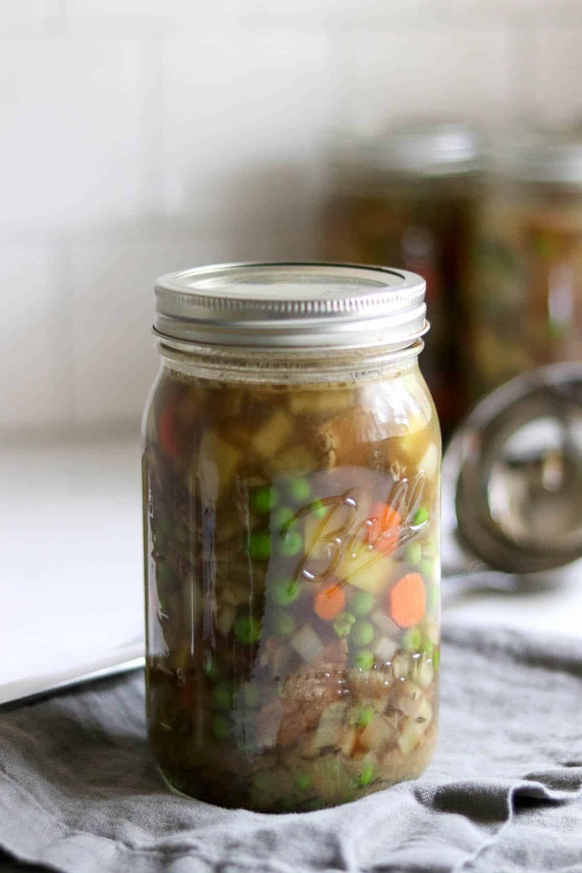 Beef pot pie filling canned in a glass jar.