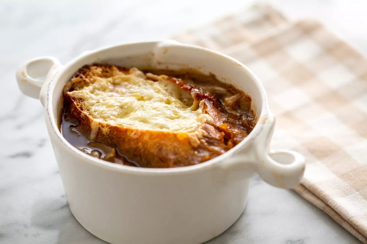 Scrumptious french onion soup in a small bowl.
