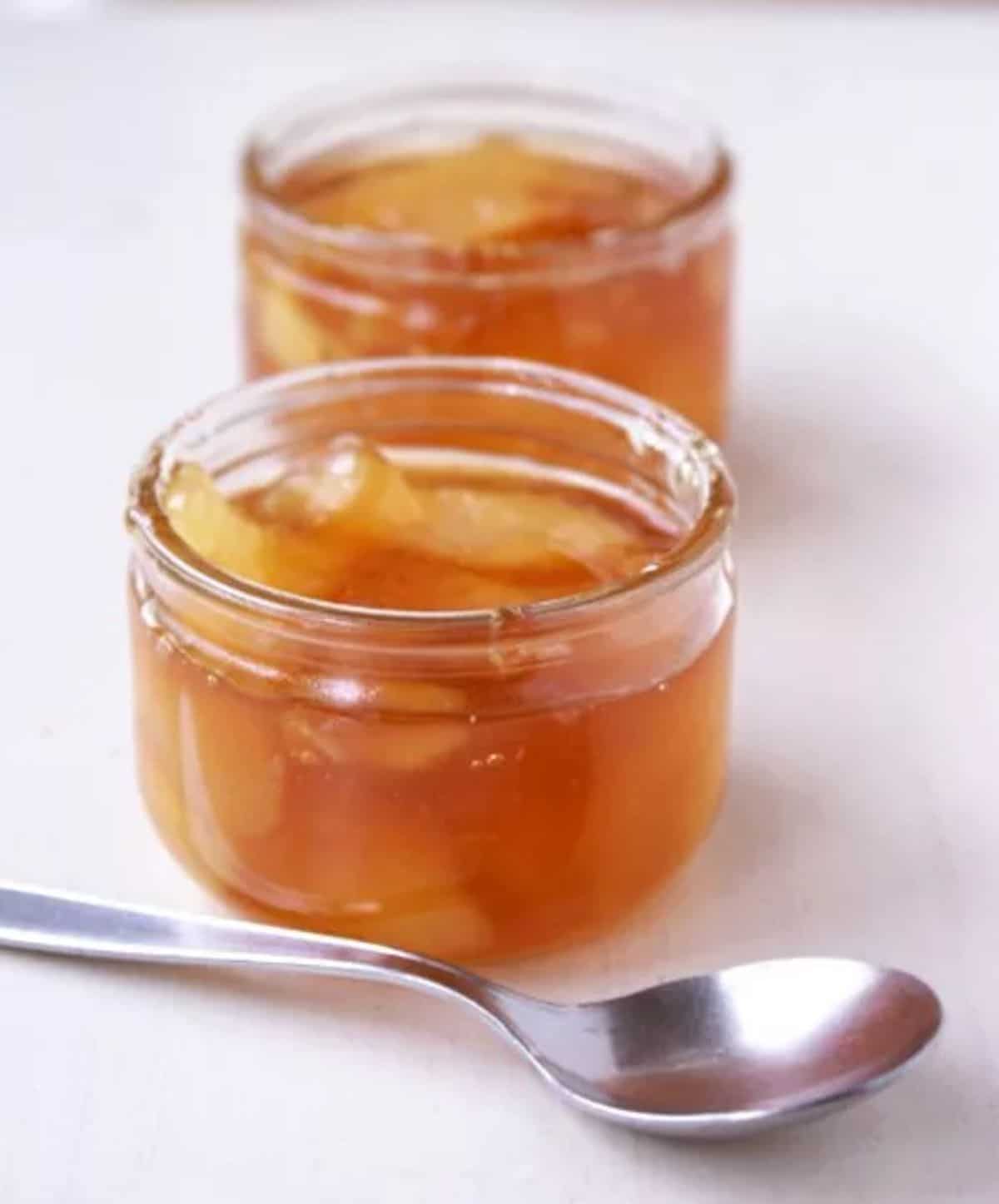 Pear jam with red tea in glass jars.