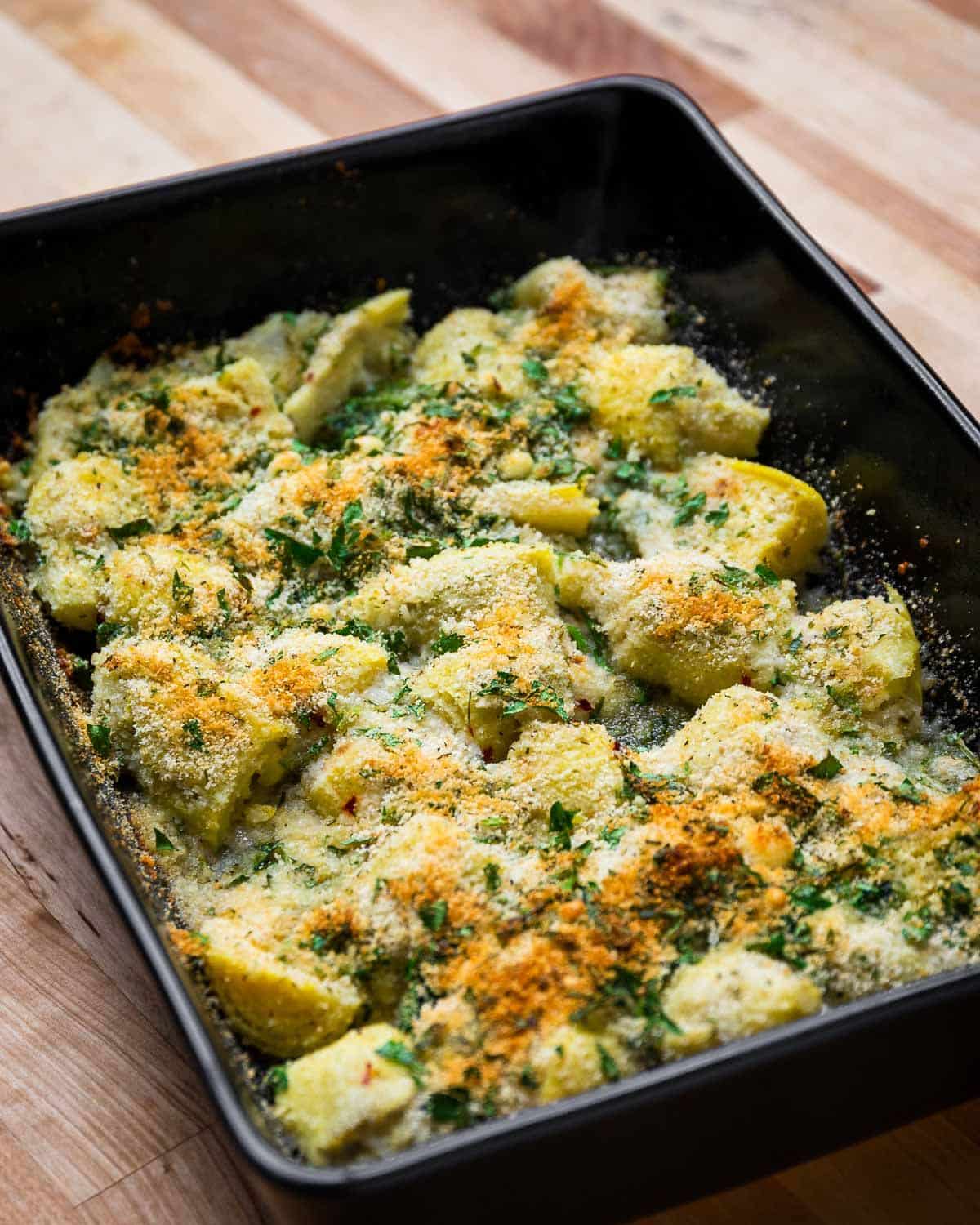 Italian artichoke hearts in a black casserole.