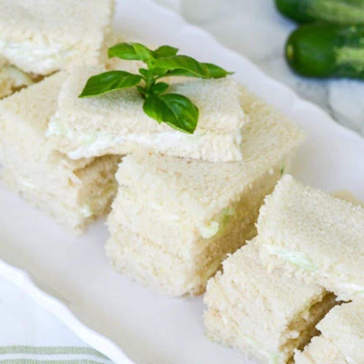 Cucumber sandwich spreads on a white tray.