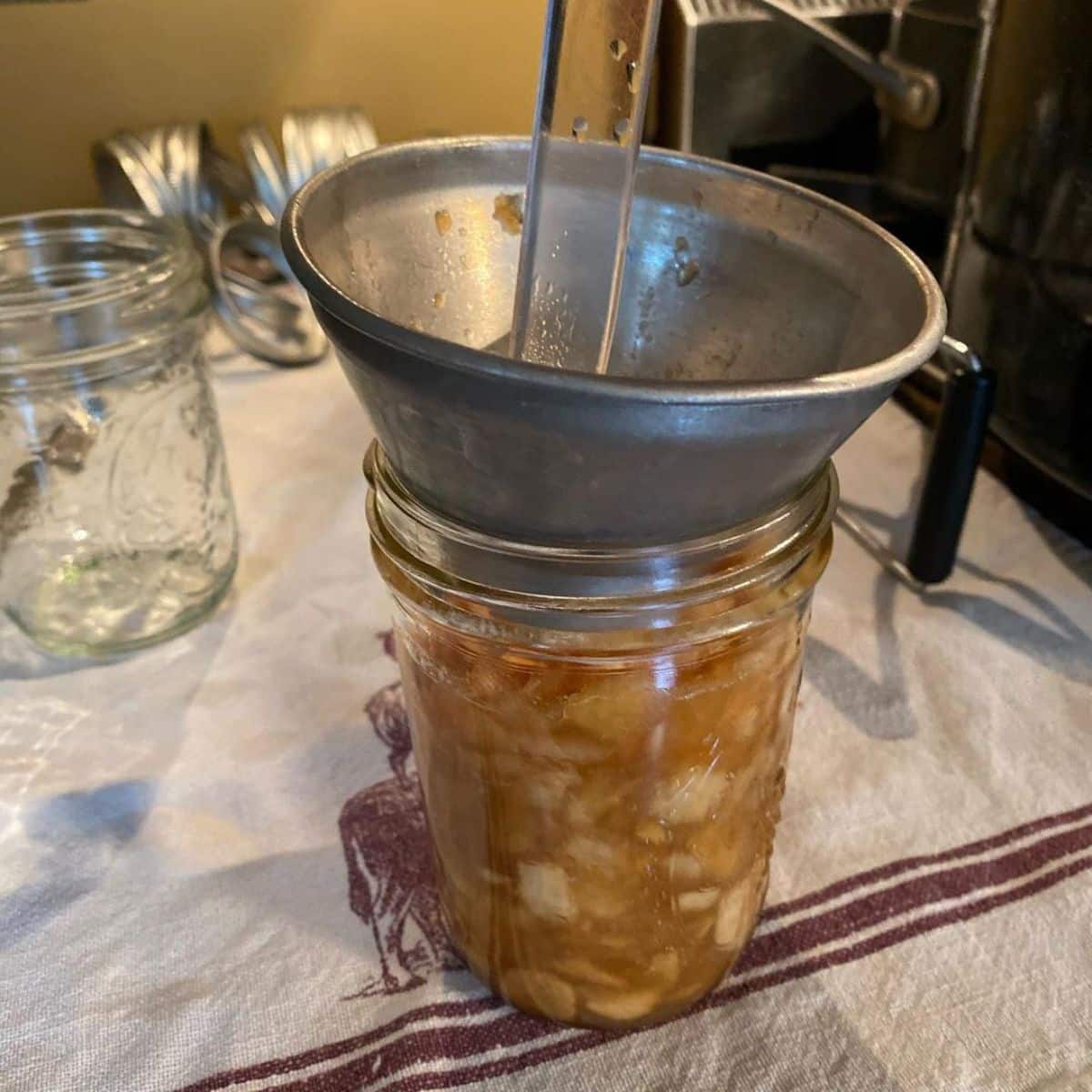 Homemade applesauce poured into a glass jar.