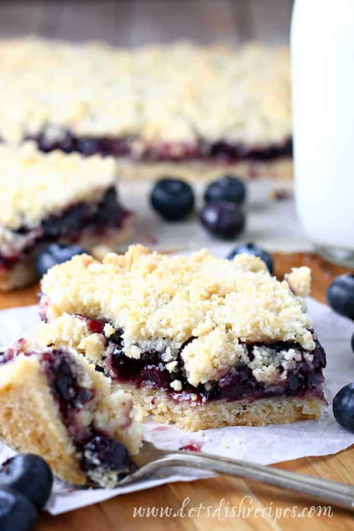 Blueberry pie bar on a paper napkin.