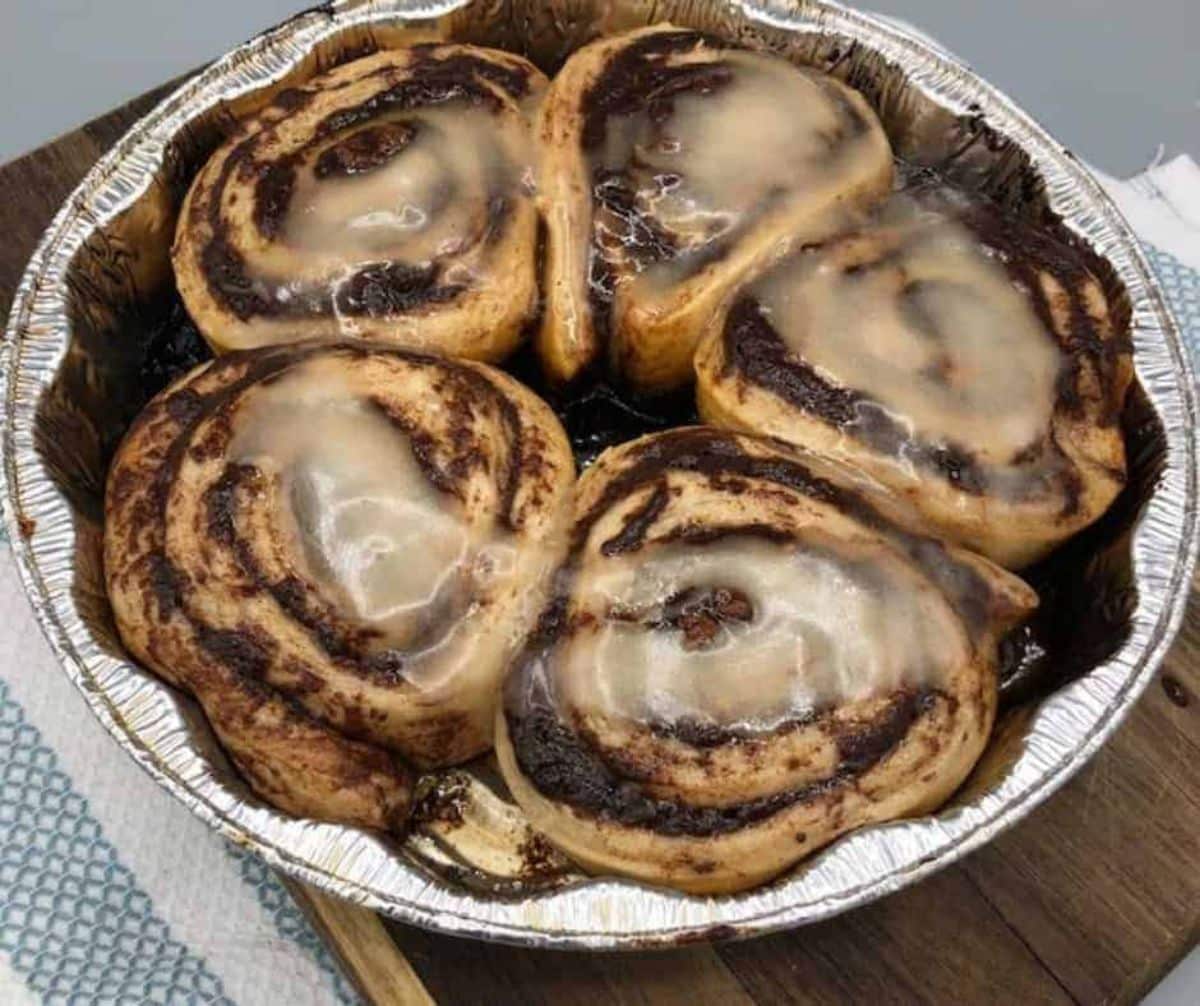 Blackstone griddle cinnamon rolls in a baking tray,