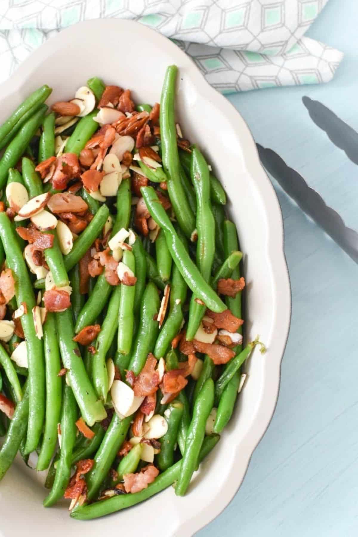 Healthy garlic bacon sauteed green beans made with lard in a white bowl.