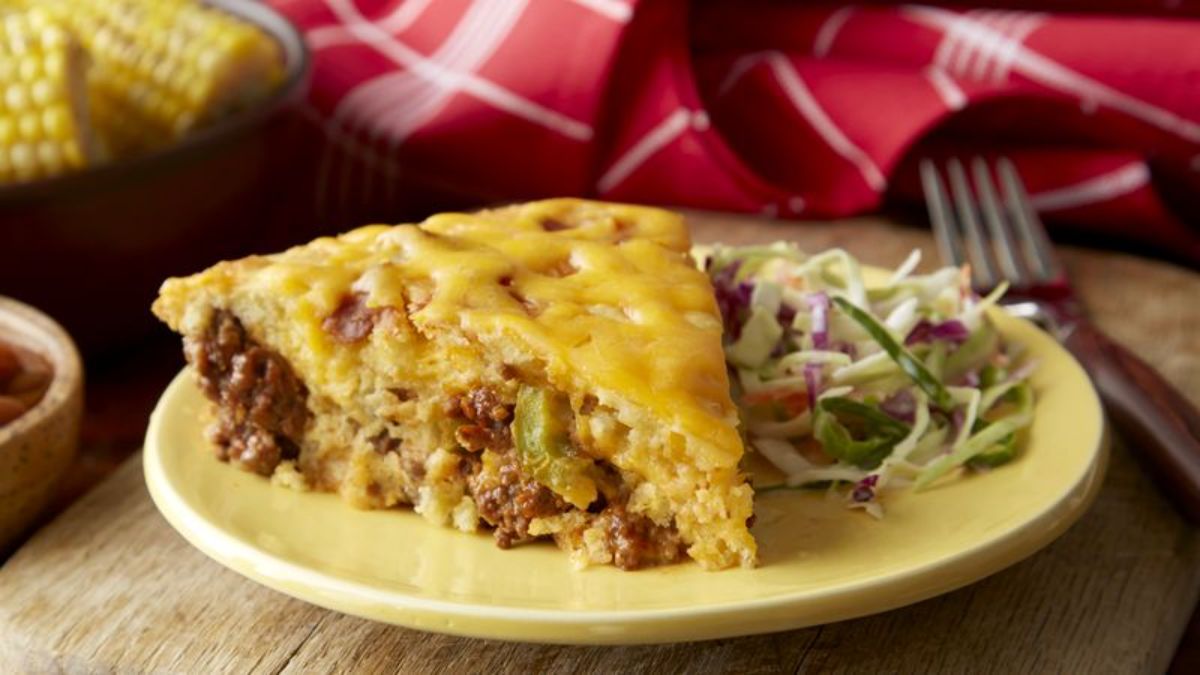 A piece of barbecue beef pie on a yellow plate.