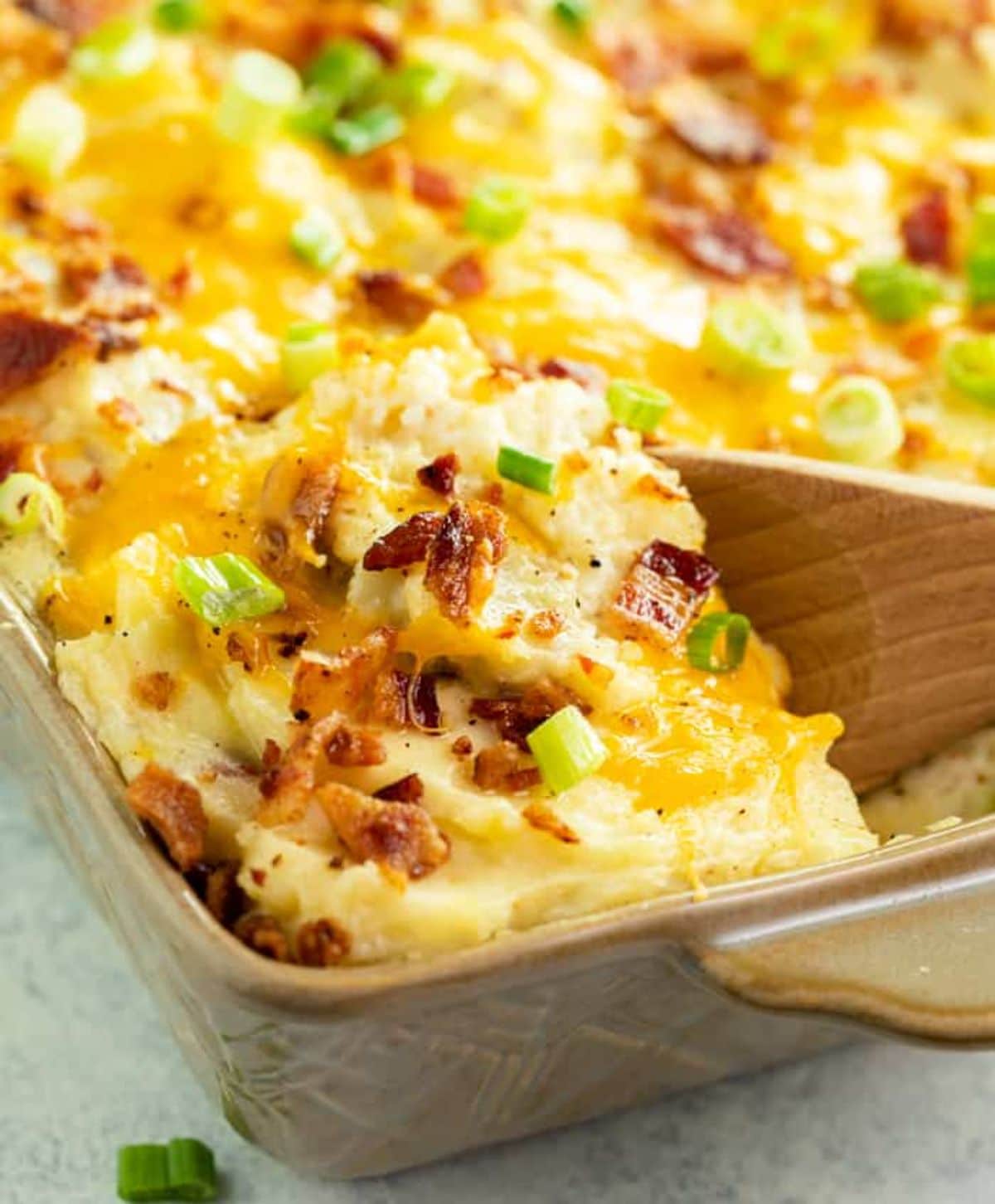 Twice-baked potato in a brown casserole.