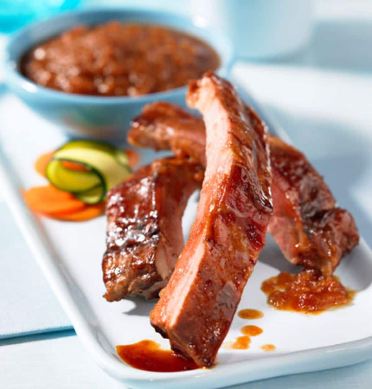 Canned pork spareribs on a white tray.