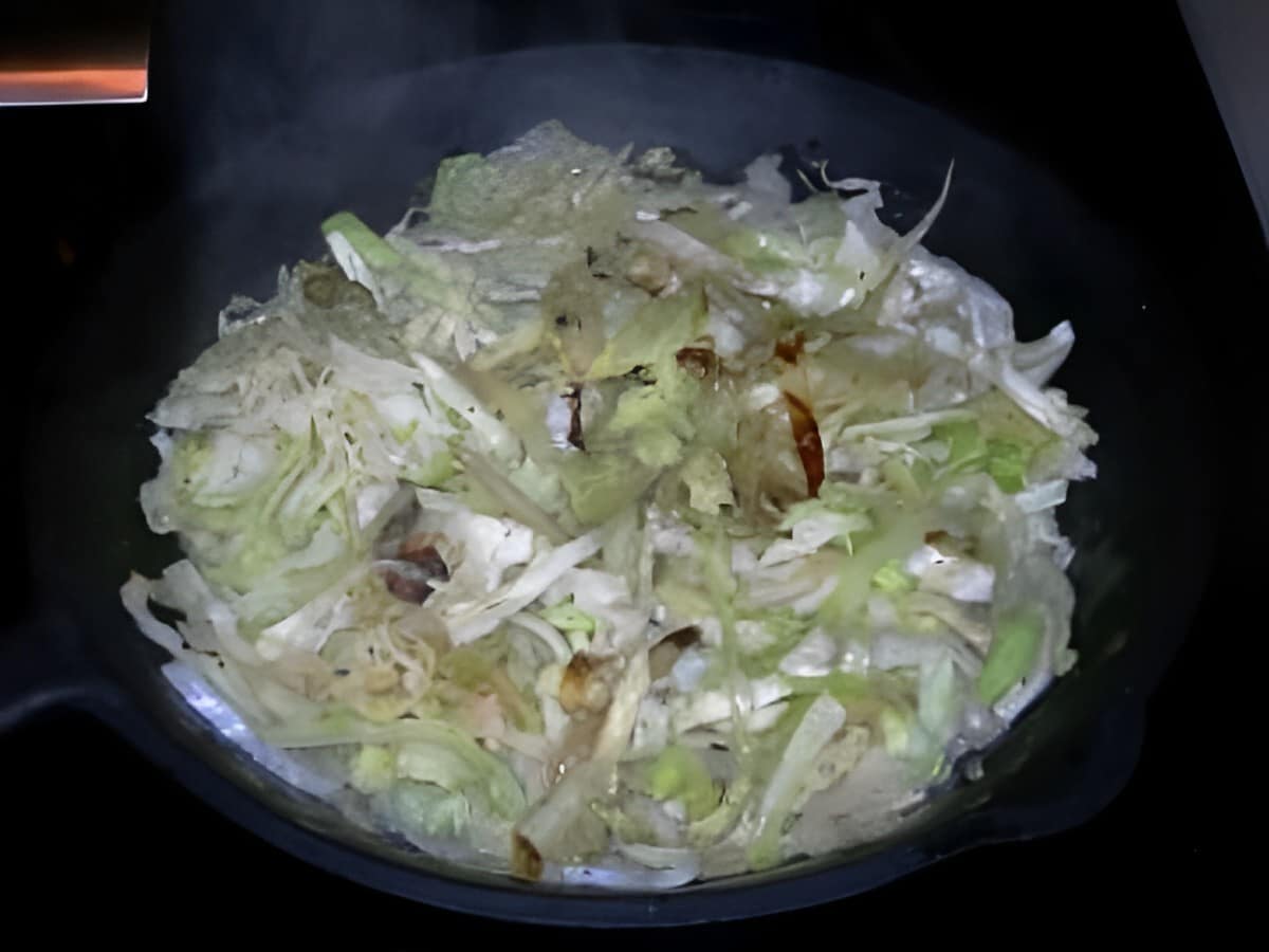 Ina garten's sauteed cabbage in a black bowl.
