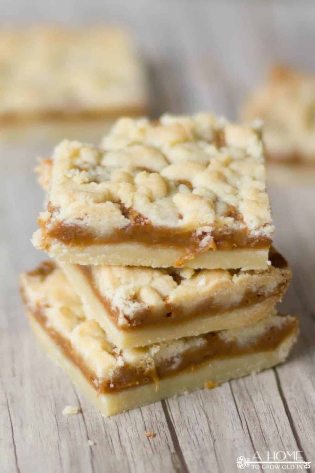 A stack of salted caramel butter bars on a wooden table.