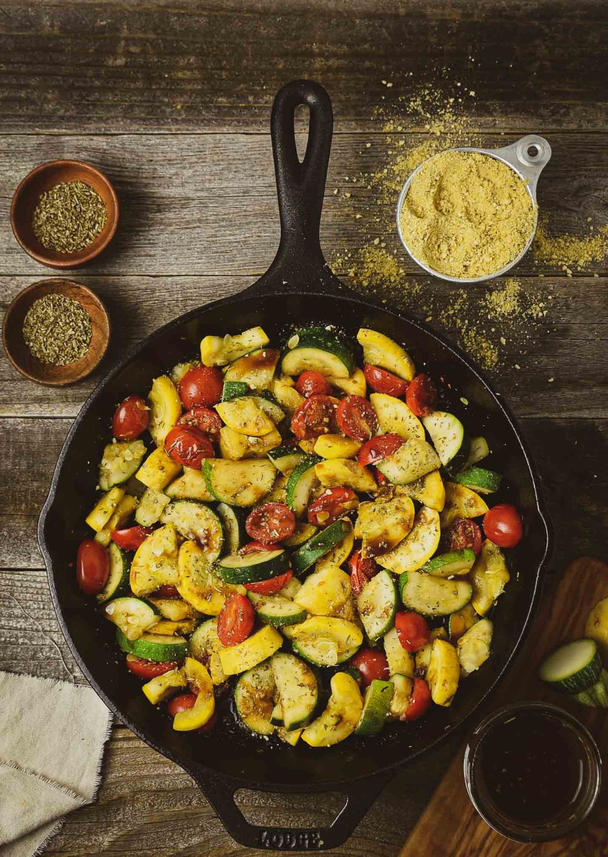 Summer squash saute in a black skillet.