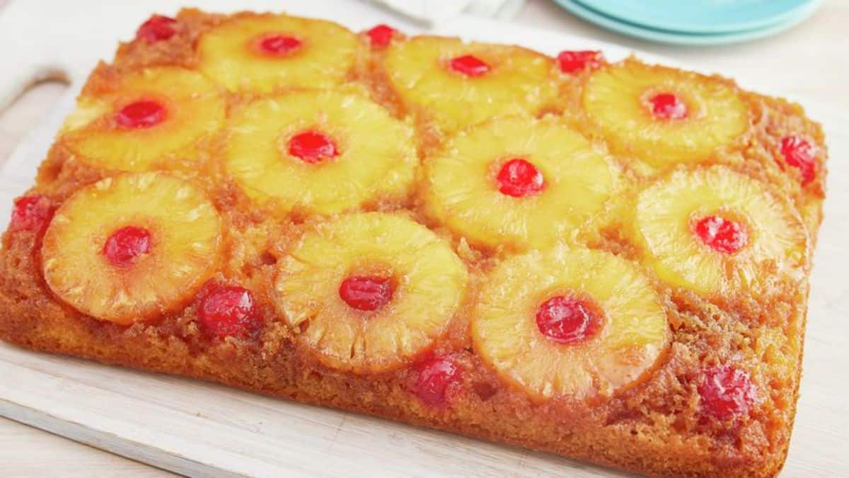 Deliicous pineapple upside down cake on a white tray.
