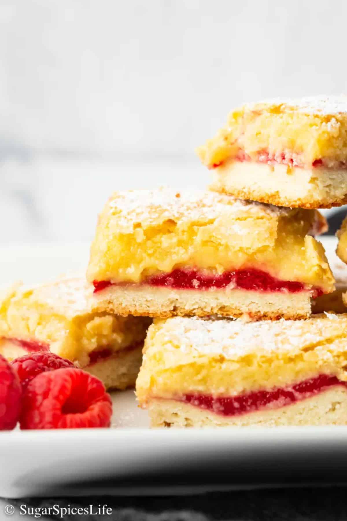 Raspberry almond bars on a white plate.