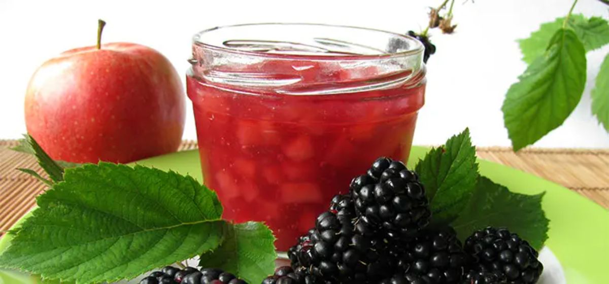 Delicious apple and blackberry jelly in a glass jar.